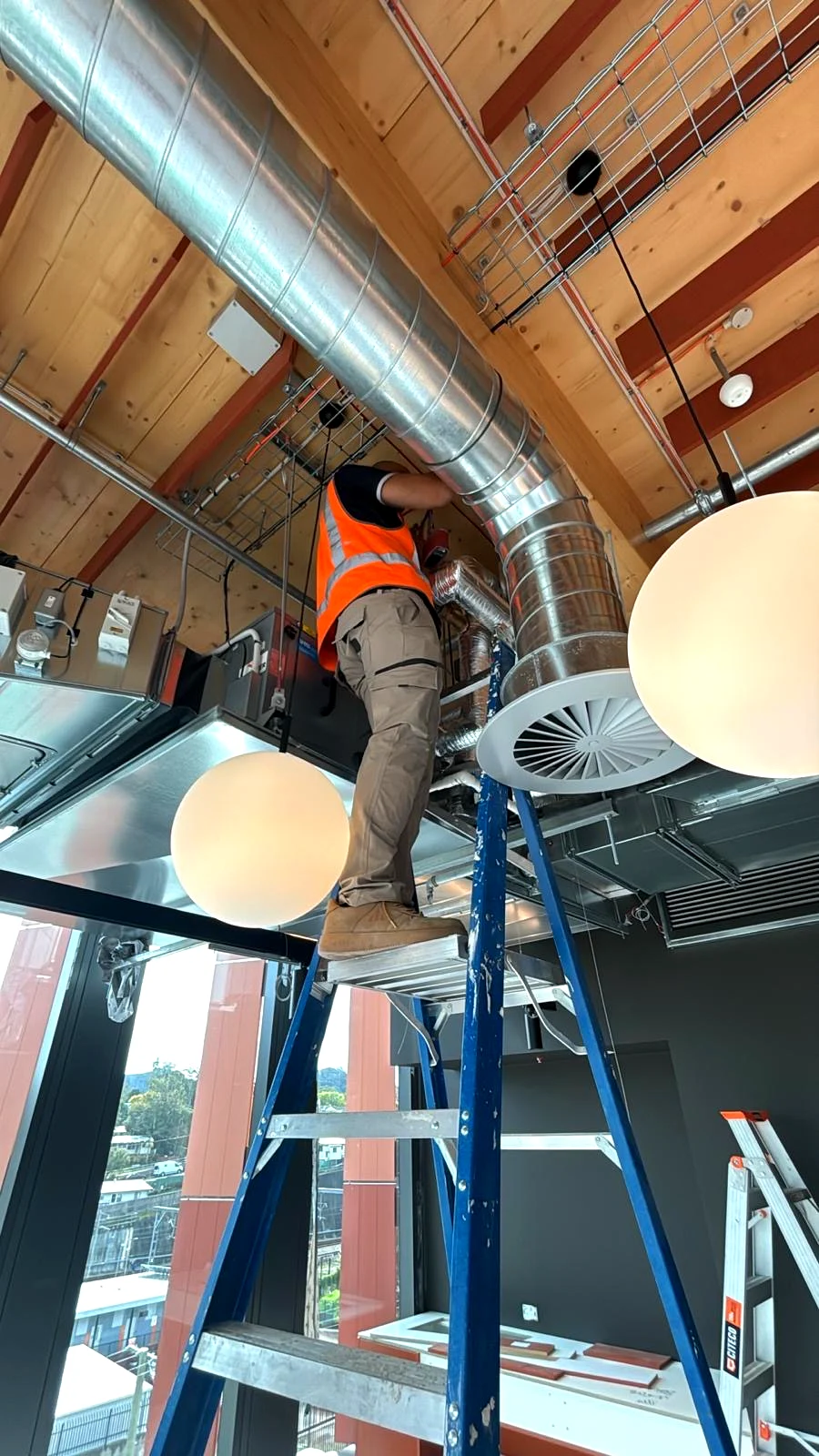 Flowtest technician balancing ductwork on site